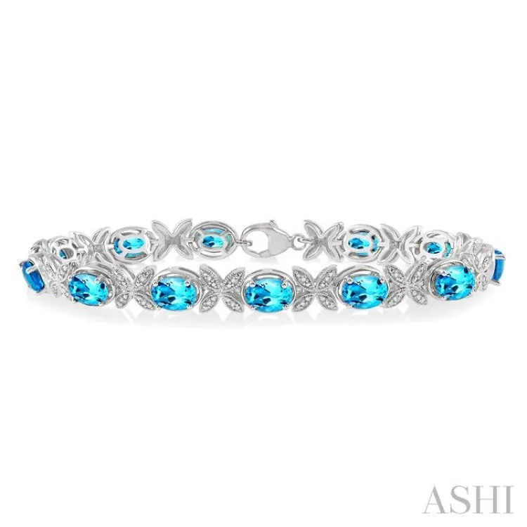 1/10 Ctw Round Cut Diamond & 7x5MM Oval Cut Blue Topaz Semi Precious Bracelet in Sterling Silver